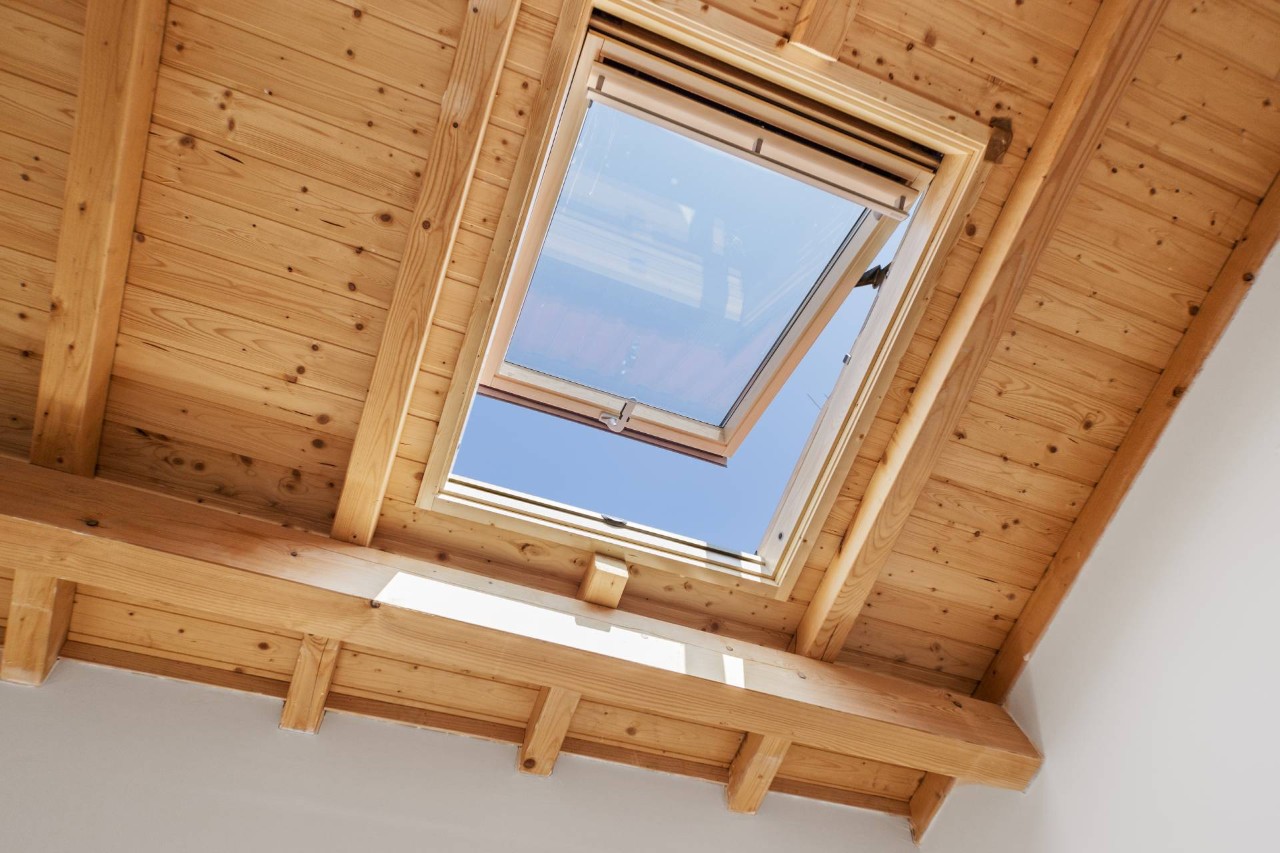 A skylight window with a wooden frame and ceiling at Blinds & Shutters of All Kinds near Newhall, CA
