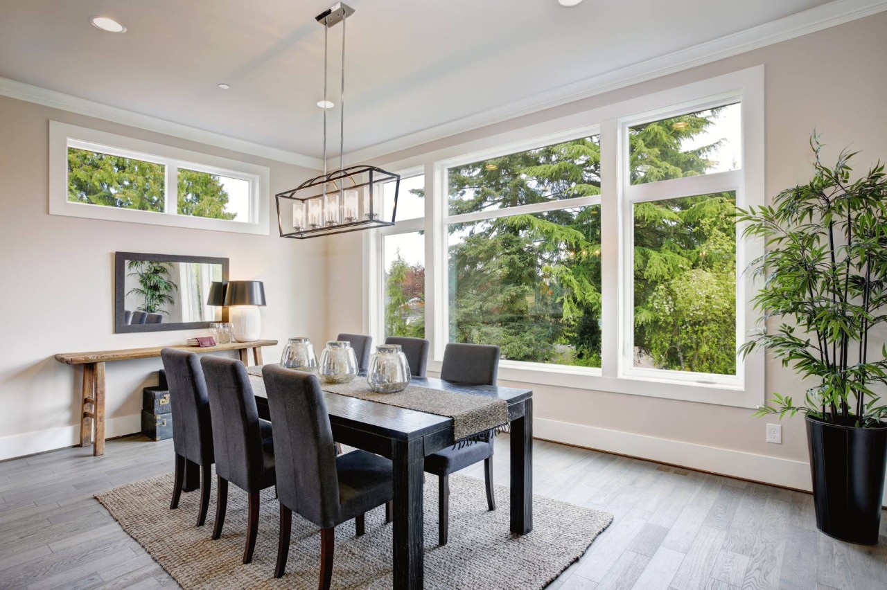 A dining room with picture windows that look out into the woods  at Blinds & Shutters of All Kinds near Newhall, California (CA)